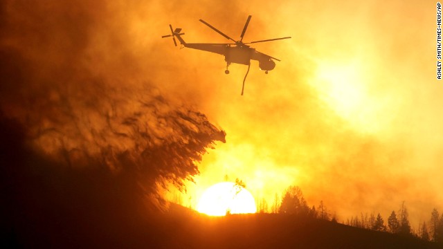 A helicopter makes a drop while battling the Beaver Creek Fire on August 17.