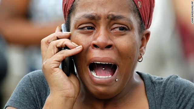 Nicole Webb gets emotional while waiting for her 9-year-old son after gunshots were fired at his school in Decatur, Georgia, on Tuesday, August 20. A gunman who opened fire at Ronald E. McNair Discovery Learning Academy was armed with an AK-47 "and a number of other weapons," police said. There were no reports of injuries.