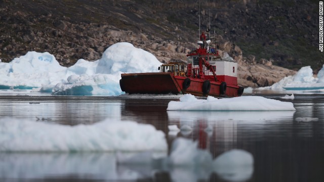 A boat navigates among calved icebergs from the nearby Twin Glacier on July 31 near Qaqortoq. Boats are a crucial mode of transportation in a country that has few roads. 