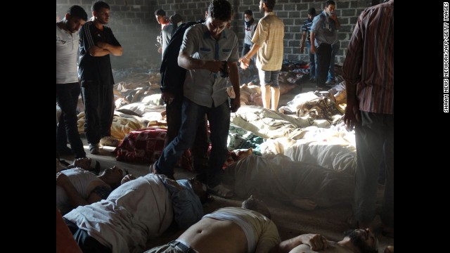 Syrian rebels claim pro-government forces used chemical weapons to kill citizens outside Damascus on Wednesday, August 21. People inspect bodies in this photo released by the Syrian opposition Shaam News Network.