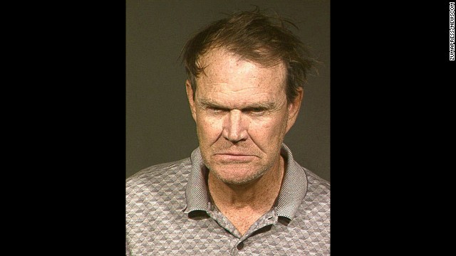 Country singer Glen Campbell was arrested in Phoenix on November 25, 2003, on drunken driving and hit-and-run charges. According to Arizona police, the 67-year-old performer hit another car and left the scene. He was later picked up at his home where he smelled of booze and kneed a sergeant in the thigh. Seen Campbell poses for his mugshot in 2004 after checking into a Phoenix lockup to serve his first of 10 nights in jail. He pleaded guilty to the charges.