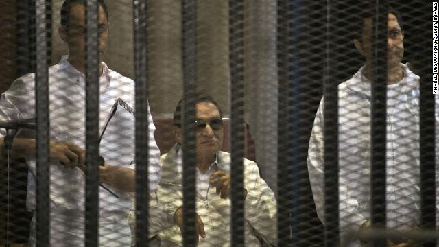 Mubarak and his sons Gamal, left, and Alaa are seen behind the defendants' cage during their retrial at the Police Academy in Cairo. Mubarak was granted a retrial. Later, a court ordered Mubarak be freed, pending his retrial.