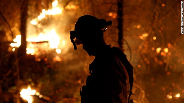 A firefighter from Cosumnes Fire Department monitors a back fire while battling the Rim Fire on August 22, in Groveland, California. 