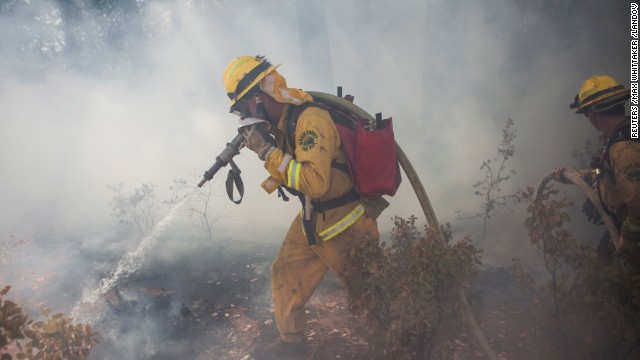 A Marin County firefighter works to put out a spot fire that jumped a fire line on the Rim Fire near Groveland, California, August 22.