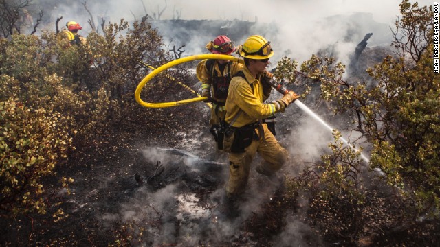A firefighting crew puts out a spot fire that jumped a fire line in Yosemite National Park on August 23.