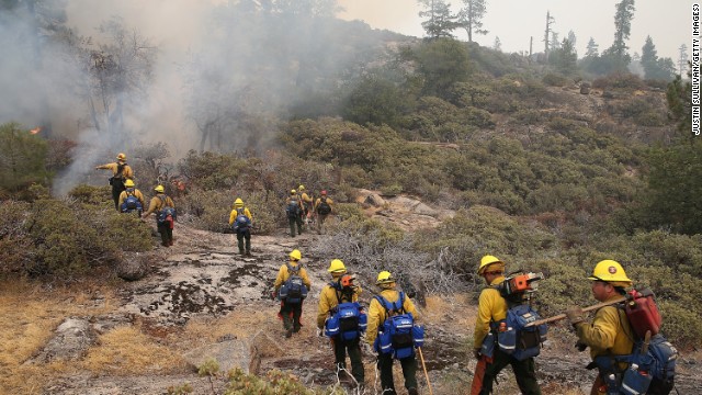 Firefighters move in to douse a spot fire on August 24. 