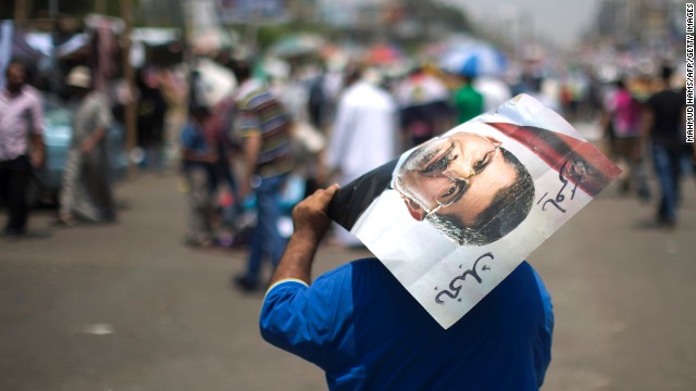 A supporter of the Muslim Brotherhood holds a poster of deposed president Mohamed Morsy in July.