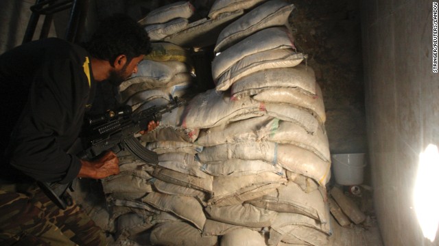 A Free Syrian Army fighter takes position behind sandbags in the old city of Aleppo, Syria, on Tuesday, August 27. 