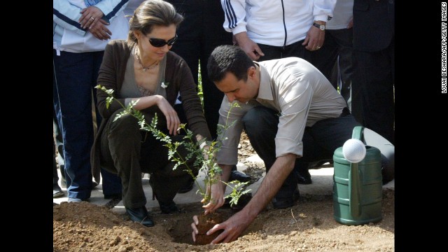 Asma al-Assad plants a jasmine bush with her husband in old Damascus on April 27, 2007. 