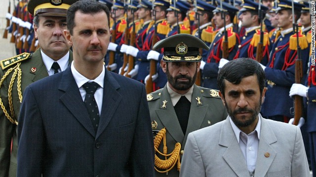 Al-Assad and Iran's Mahmoud Ahmadinejad review the honor guard at Damascus airport on January 19, 2006. 