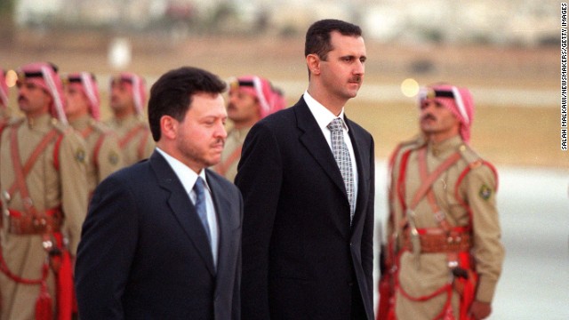 Jordanian King Abdullah ll and al-Assad inspect the honor guard on October 18, 2000, in Amman, Jordan.