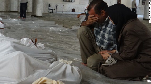 A man mourns over the bodies of those killed in a suspected chemical weapon attack in a suburb of Damascus, Syria, on Wednesday, August 21. Syrian rebels said that poisonous gas rained down from rockets overnight, but authorities have denied the allegations that they used chemical weapons and accused the opposition of staging the attacks. U.S. officials, however, said there were 