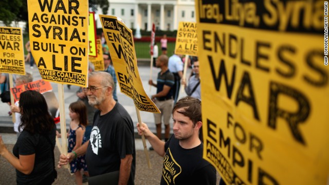 Demonstrators, including former CIA analyst Ray McGovern, second from left, gather on the north side of the White House to protest possible U.S. military action against Syria on August 29.
