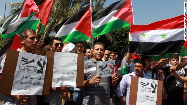 Palestinians, waving the Syrian and Palestinian national flags, demonstrate against possible Western military intervention in Syria in the West Bank city of Nablus on August 29.