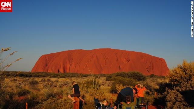 Uluru, otherwise known as Ayers Rock, is a large sandstone rock formation in Northern Territory, Australia. <a href='http://ireport.cnn.com/docs/DOC-982953'>Anusha Mookherjee </a>took this photo back in 2011 and said the visit was calming. "There is absolutely no noise pollution, and only families sitting around waiting for the sunset," she said.