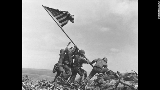 Joe Rosenthal's 1945 photograph of U.S. troops raising a flag in Iwo Jima during World War II remains one of the most widely reproduced images. It earned him a Pulitzer Prize, but he also faced suspicions that he staged the patriotic scene. While it was reported to be a genuine event, it was the second flag-raising of the day atop Mount Suribachi. The first flag, raised hours earlier, was deemed too small to be seen from the base of the mountain. Look back at other photographs that have helped define modern history.