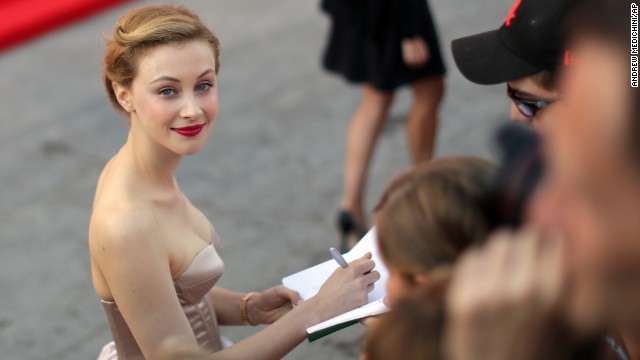 Actress Sarah Gadon signs autographs as she arrives for the screening of the film "Joe" on Friday, August 30.