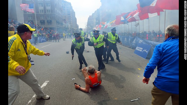 Boston Globe photographer John Tlumacki was near the finish line when 78-year-old runner <a href='http://piersmorgan.blogs.cnn.com/2013/04/15/bill-iffrig-subject-of-iconic-boston-globe-photo-the-shock-waves-hit-my-whole-body-my-legs-just-started-jittering-around-i-knew-i-was-going-down/'>Bill Iffrig was knocked down</a> by the first explosion at the Boston Marathon on April 15. The bombings left three people dead and injured more than 100. Iffrig got up and finished the race. Tlumacki's image of the fallen runner was widely published and selected for the cover of "Sports Illustrated."