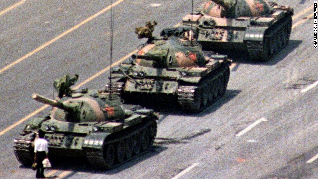 Following a crackdown that resulted in the deaths of hundreds of student demonstrators in Beijing, a lone Chinese protester steps in front of People's Liberation Army tanks in Tiananmen Squarein 1989. At least five photographers captured the event, which became a symbol of defiance in the face of oppression. Charlie Cole, working for Newsweek, won a World Press Photo Award for his version of the image. The identity and fate of the "Tank Man" remains unclear.