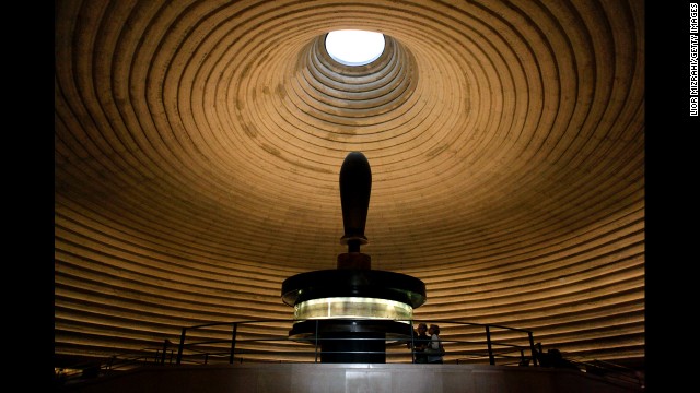 People look at the Isaiah Scroll, one of the Dead Sea Scrolls, inside the vault of the Shrine of the Book at the Israel Museum. With more than 200 museums, Israel has the highest number of museums per capita in the world. Here is a <a href='http://travel.cnn.com/best-israel-museums-361281'>list of 10 of the best</a>.