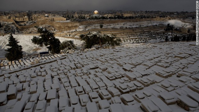 Tombs sit covered in snow at the Jewish cemetery at the Mount of Olives. There are spectacular views at the summit.