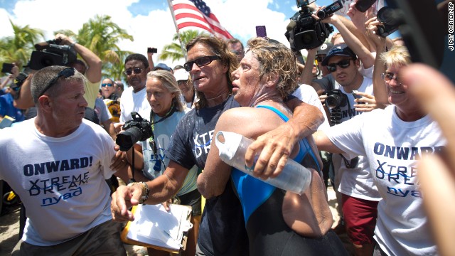 Nyad and her trainer Bonnie Stoll hug as Nyad walks ashore on September 2.