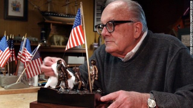 Artist Jim Conrad designed a sculptured bronze version of the flag raising in honor of the Rev. Mychal Judge, a New York Fire Department chaplain who lost his life while administering last rites on September 11, 2001. Conrad is seen polishing the sculpture in 2002 at his home in Lakewood, Colorado.