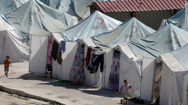 Children run past tents at a Syrian refugee camp in Yayladagi, Turkey, on Tuesday, September 3. The U.N. refugee agency said that the number of Syrians who have fled their war-ravaged country has risen to more than 2 million.