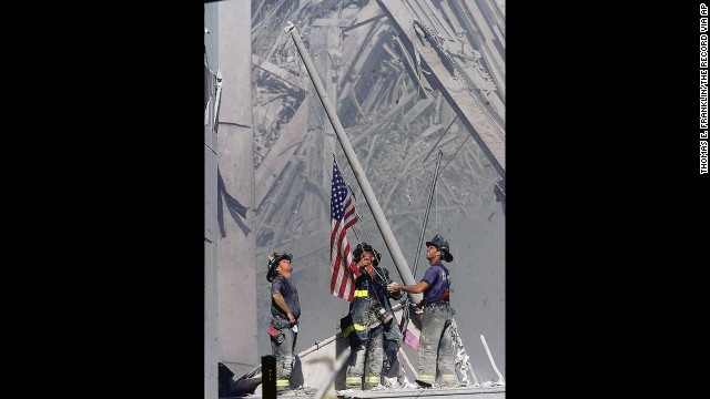 Firefighters George Johnson, Dan McWilliams and Billy Eisengrein raise a flag at ground zero in New York after the terror attacks on September 11, 2001. The scene was immortalized by photographer Thomas E. Franklin. The image has been widely reproduced in the decade since it was first published. <a href='http://www.cnn.com/2013/09/01/world/gallery/iconic-images/index.html'>View 25 of history's most iconic photographs.</a>