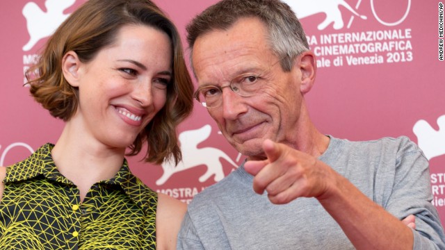 Director Patrice Leconte, right, points at photographers while posing with actress Rebecca Hall during the photo call for the film "A Promise" on September 4.