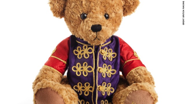 The latest addition to the British royal family, Prince George of Cambridge, was gifted a teddy dressed in the queen's silks, by a leading horse racing organization. 