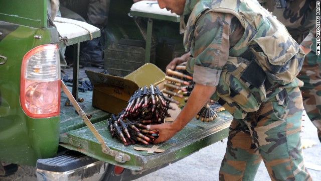 A Syrian soldier prepares large-caliber bullets for a machine gun in Maaloula on September 7. 