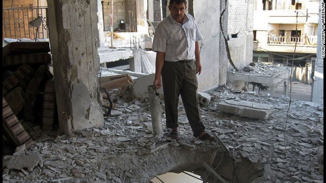 A man stands inside a home damaged by heavy shelling in Arbeen, a suburb of Damascus, Syria, on September 7. 