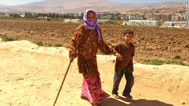 A Syrian looking for safety crosses the border into Lebanon every 15 seconds. Most of the children can be found without their parents, who stay in Syria to work and protect their homes. This boy, age 9, walks with his grandmother back to their tent. He told Gupta's producer, Danielle Dellorto, that he asks every day if they can go back home to Syria. 