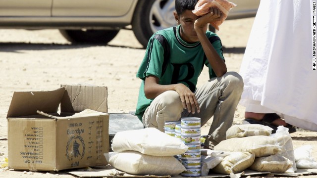 A young Syrian refugee boy sells canned tuna and other food items in the Zaatari Refugee Camp on September 4. 