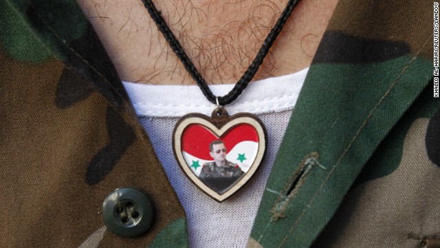 A soldier wears a picture of Syrian President Bashar al-Assad on his chest while at a market in old Damascus on September 8.