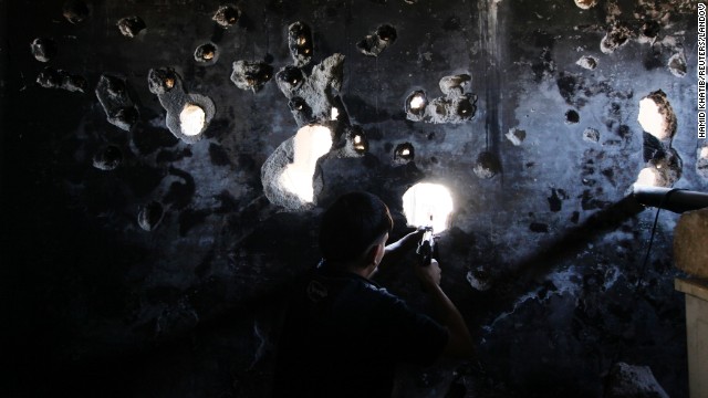 A Free Syrian Army fighter takes up a shooting position in Aleppo on September 8.