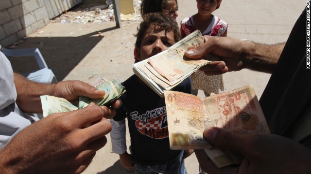 A refugee money-changer exchanges currency at the main market at the Zaatari refugee camp near the Jordanian city of Mafraq on Sunday, September 8. 