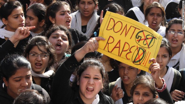 Protesters hold signs in outrage over the gang-rape and death of a 23-year-old student in Delhi in 2012.