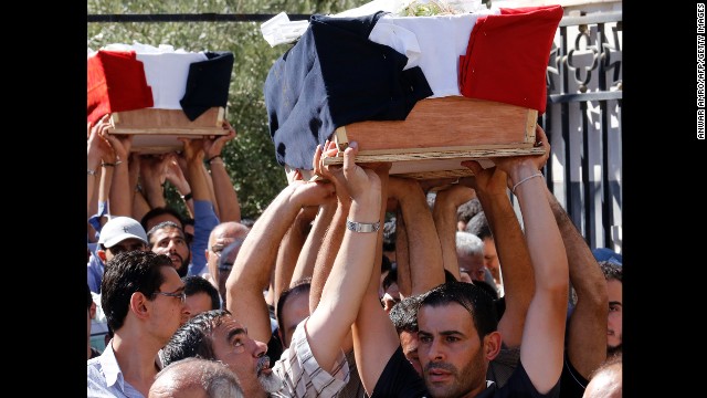 A funeral is held on September 11 for three Christian Syrians killed during battles with an al Qaeda-linked rebel group that took control of the historic Christian town of Maaloula from regime forces during the weekend.
