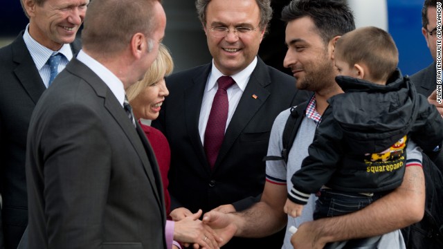 Lower Saxony's Commissioner for Migration and Participation Doris Schroeder-Koempf, along with German Interior Minister Hans-Peter Friedrich, center, greet the first of many Syrian refugees that have been granted temporary asylum in Germany on Wednesday, September 11. According to the The United Nations refugee agency, the refugees will be issued with a permit to stay for at least two years. The agency said that the number of Syrians who have fled their war-ravaged country has risen to more than 2 million.