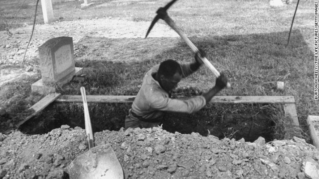 A man digs a grave for one of the girls.
