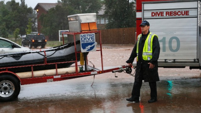 A dive rescue team moves toward floodwaters in Boulder on September 12.