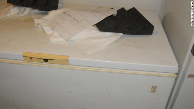 A freezer next to the door to the soundproof room. Sitting on top are pieces of black foam to make the room soundproof.