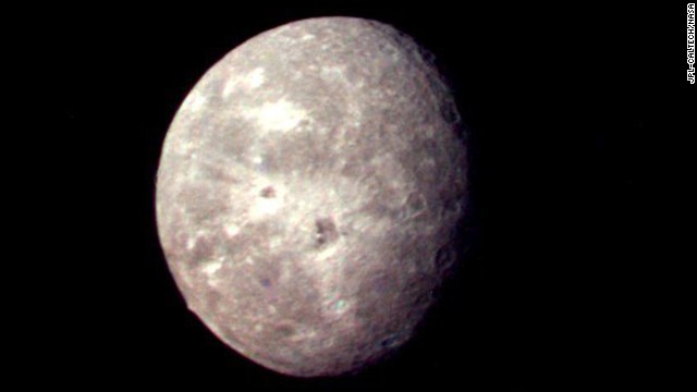 Oberon, Uranus' outermost moon, shows several impact craters on the moon's icy surface. 