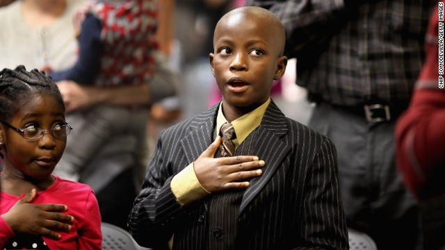  Born in Liberia, Cynthia Newton, left, and her brother, James, say the Pledge of Allegiance during their 2011 citizenship ceremony.