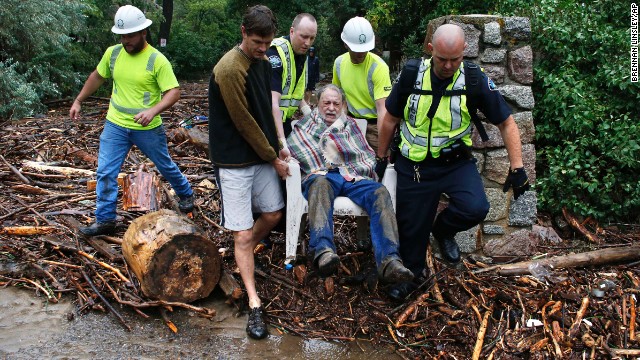 Will Pitner gets rescued by emergency workers and neighbor Jeff Writer, on September 13 after he spent a night trapped outside above his home at the base of Boulder Canyon.