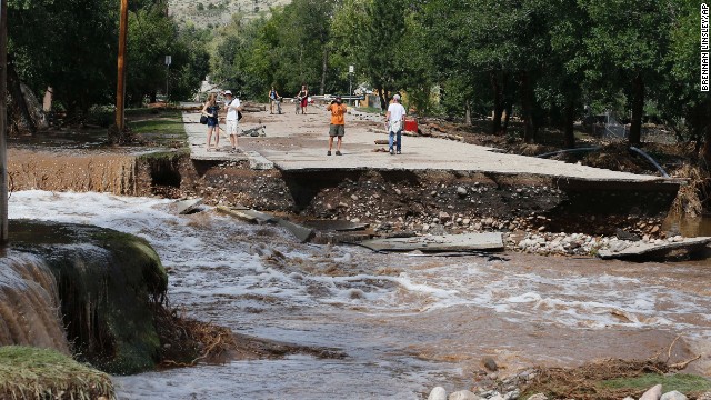 Water rushes where a bridge collapsed in a flash flood in Lyons, on September 13. 