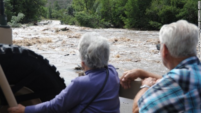 Dick and LaRue Vodime, temporary residents of Lyons, Colorado, witness some of the destruction from the floods as they are evacuated to Longmont, Colorado, on September 13. 