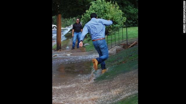A man runs through the flood waters in a yard in Boulder on September 13. 